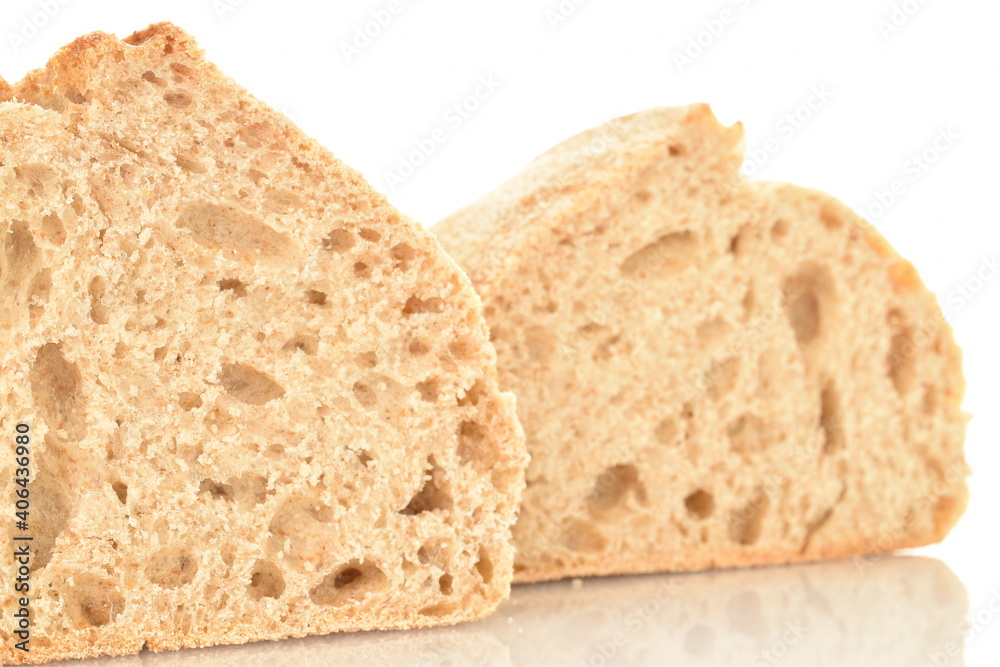 Two halves of a fragrant loaf without yeast with bran flakes, close-up, isolated on white. Two halves of a fragrant loaf without yeast with bran flakes, close-up, isolated on white.