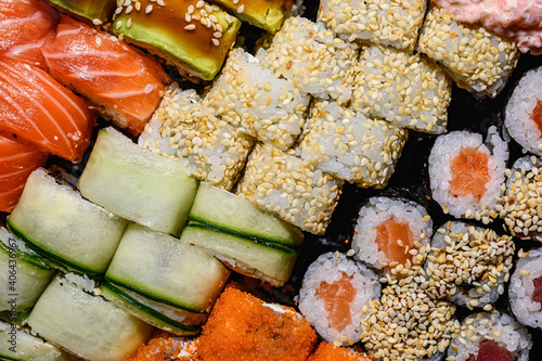 Set of sushi and rolls close-up background, delivery from a restaurant. Salmon, unagi, california and other delicious foods
