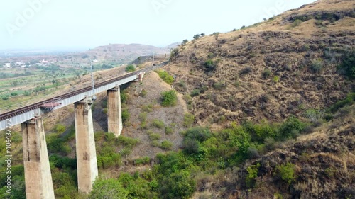 Aerial footage of a railway viaduct with electrification at Shindawane near Pune India. photo