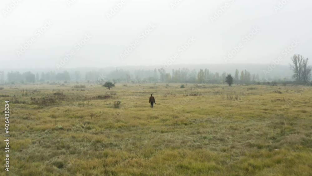 Documentarist with a camera walking in a foggy moorland,autumn,Czechia. Documentarist with a camera walking in a foggy moorland,autumn,Czechia.