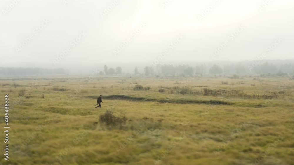 Young documentarist wading through a misty moorland,autumn,Czechia. Young documentarist wading through a misty moorland,autumn,Czechia.