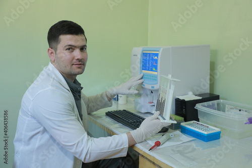 scientist looking at a microscope