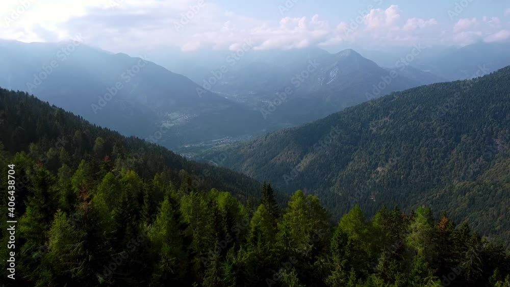 Spectacular aerial flight over the treetops on mountains with reflecting clouds and fog between shining from sunlight. Spectacular aerial flight over the treetops on mountains with reflecting clouds and fog between shining from sunlight.