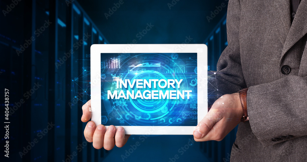 Young business person working on tablet and shows the inscription: INVENTORY MANAGEMENT, business concept Young business person working on tablet and shows the inscription: INVENTORY MANAGEMENT, business concept