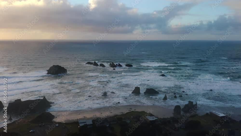 Crashing Waves Through Rock Formation Against Sunset Sky With Cloudscape At Bandon Beach, Oregon. - Aerial Drone Shot Crashing Waves Through Rock Formation Against Sunset Sky With Cloudscape At Bandon Beach, Oregon. - Aerial Drone Shot