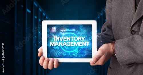 Wallpaper Mural Young business person working on tablet and shows the inscription: INVENTORY MANAGEMENT, business concept Torontodigital.ca