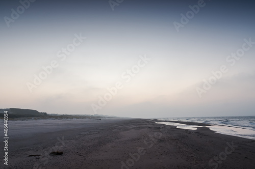 Empty quiet beach and Baltic Sea, Slowinski National Park, Leba. Fog in the background © Dominik Kopycinski