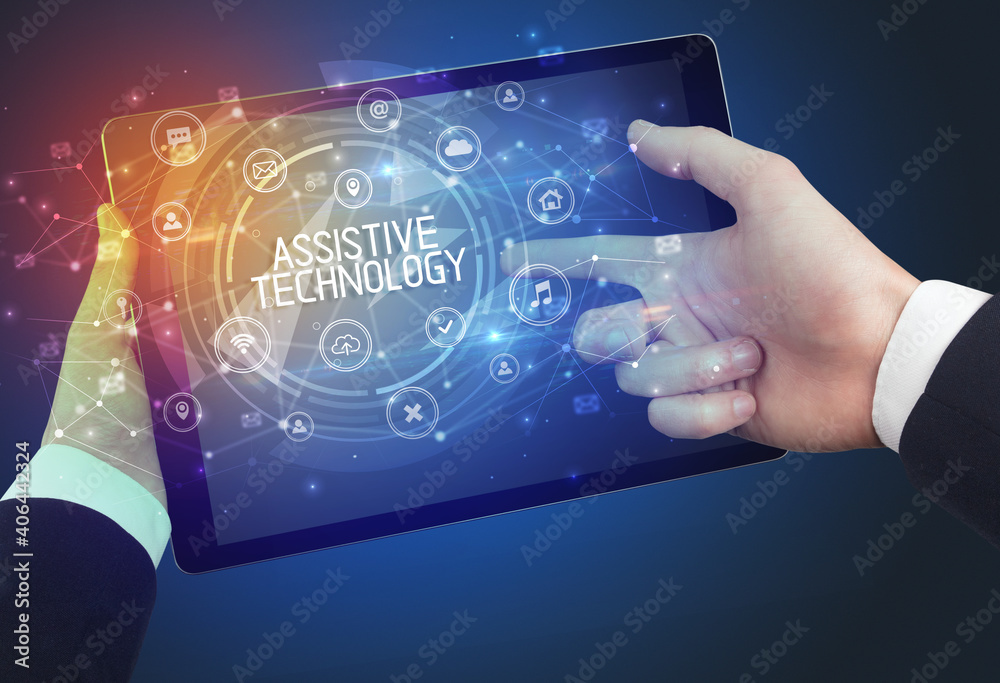 Close-up of a tablet with ASSISTIVE TECHNOLOGY inscription, innovative technology concept Close-up of a tablet with ASSISTIVE TECHNOLOGY inscription, innovative technology concept
