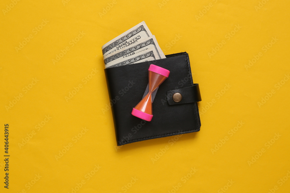 Obraz premium Time is money. Leather wallets with hourglass. on yellow background.