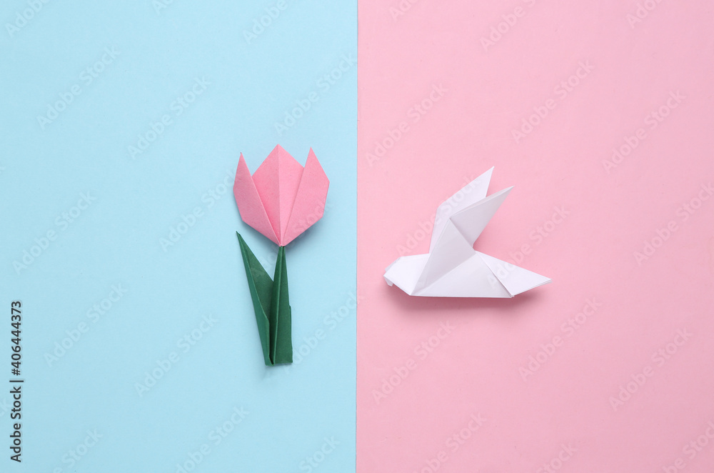 Handmade origami paper tulip and pigeons.on pink blue background. 8 March, mother's day or easter concept. Top view. Minimalism Handmade origami paper tulip and pigeons.on pink blue background. 8 March, mother's day or easter concept. Top view. Minimalism