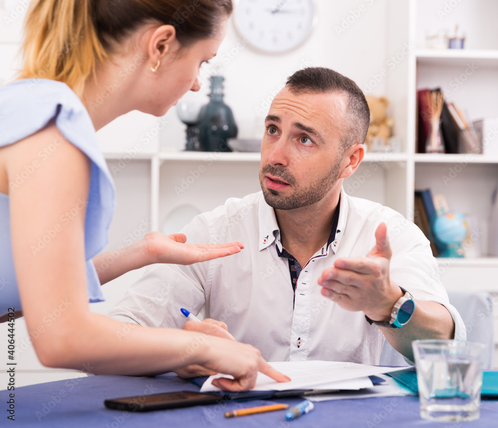 Fototapeta premium Husband is studying documents on divorce at the table at home.