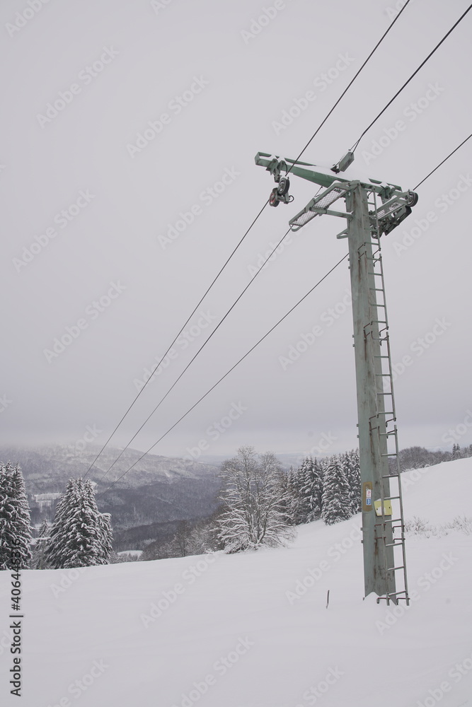 Snow covered ski lift in winter