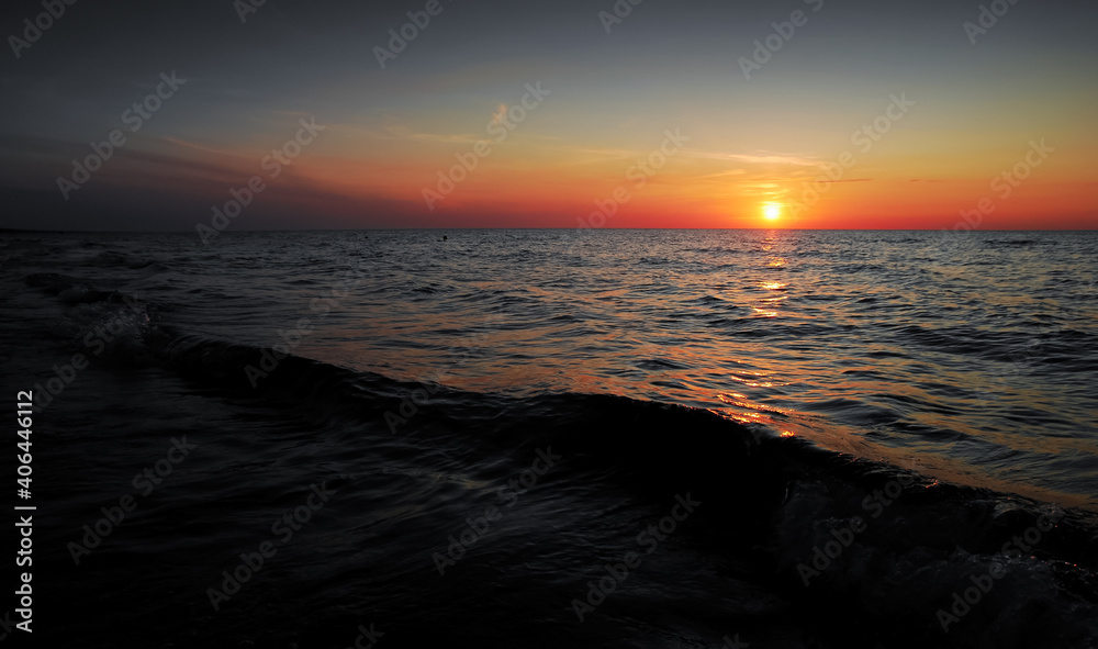 Romantic sunset over the Baltic Sea, orange vivid colors, beautiful sky, Krynica Morska