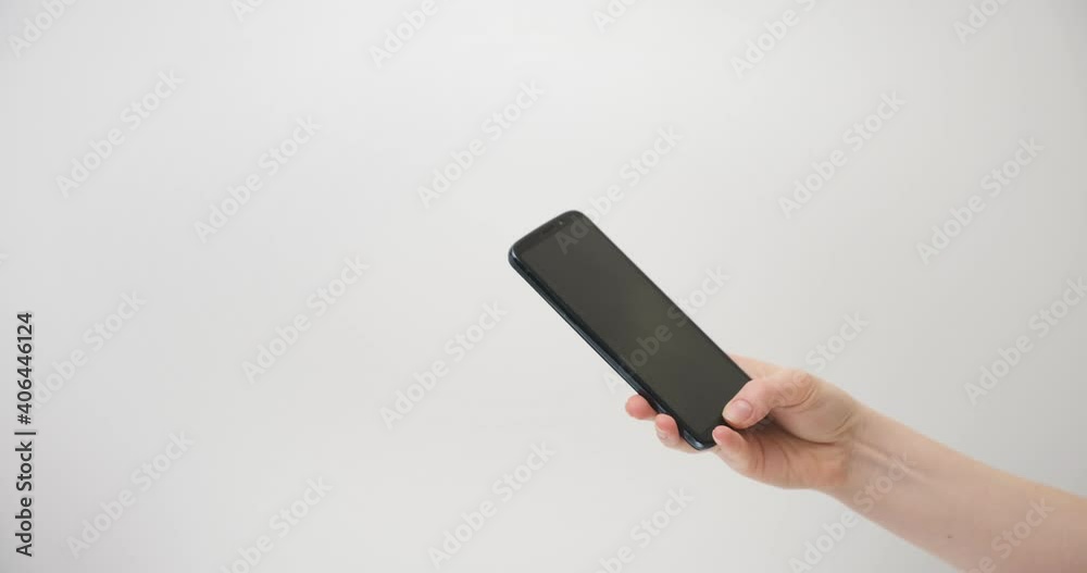 Disinfection of a mobile phone on a light background and wiping dry with a soft cloth. Disinfection of a mobile phone on a light background and wiping dry with a soft cloth.