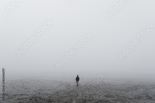 Unknown alone man in the fog, Beach, Baltic Sea, Slowinski National Park, Leba