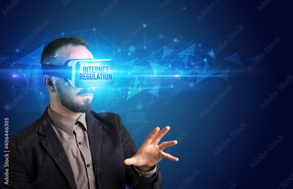 Businessman looking through Virtual Reality glasses with INTERNET REGULATION inscription, cyber security concept Businessman looking through Virtual Reality glasses with INTERNET REGULATION inscription, cyber security concept