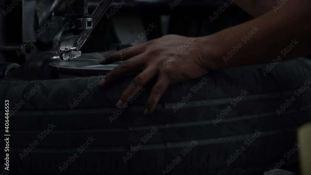 mechanic applying grease for remove old damaged and worn out of car tire tread by tire removal machinery equipment repairing . engineer repair rubber from wheel disc in workshop at car service garage mechanic applying grease for remove old damaged and worn out of car tire tread by tire removal machinery equipment repairing . engineer repair rubber from wheel disc in workshop at car service garage