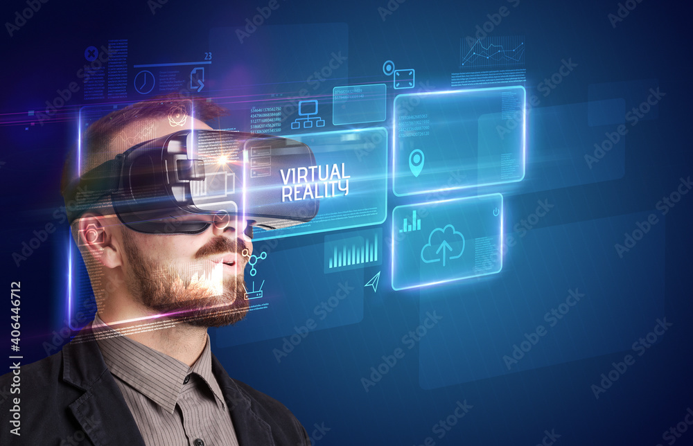 Businessman looking through Virtual Reality glasses with VIRTUAL REALITY inscription, new technology concept Businessman looking through Virtual Reality glasses with VIRTUAL REALITY inscription, new technology concept