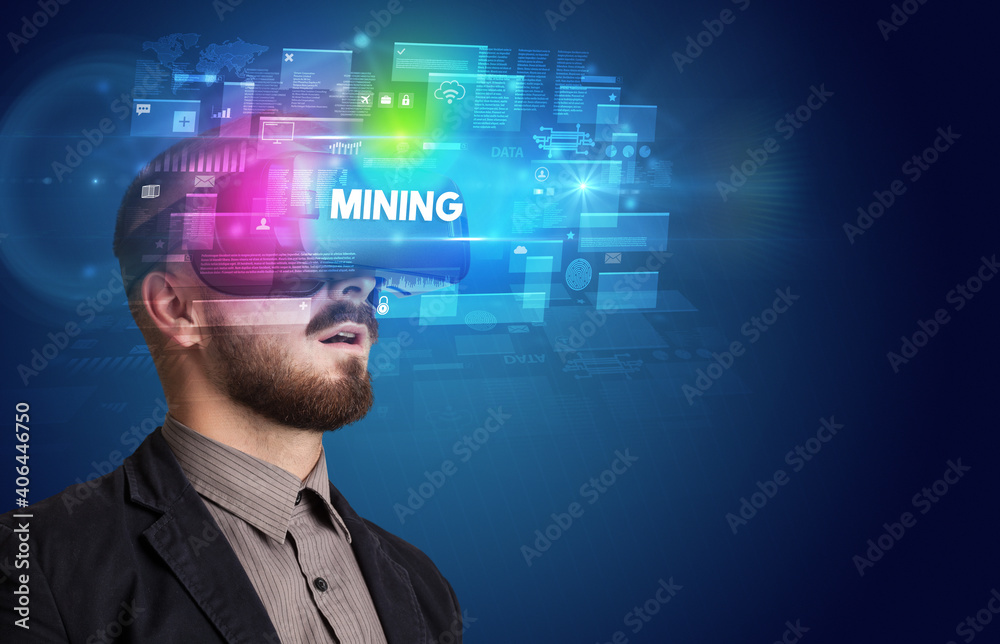 Obraz premium Businessman looking through Virtual Reality glasses with MINING inscription, innovative security concept