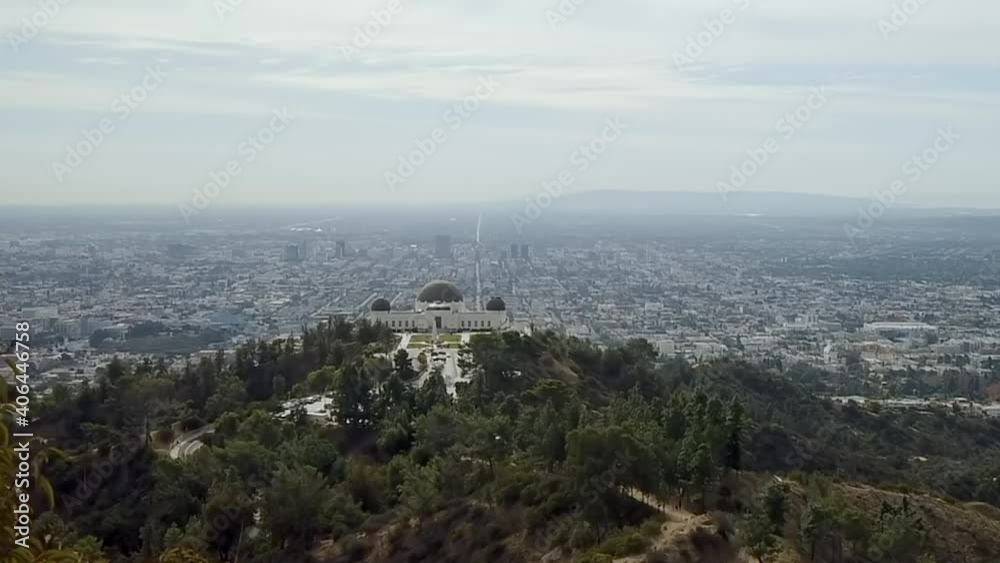 Skyline timelapse across Griffith observatory landmark downtown city Los Angeles pan right