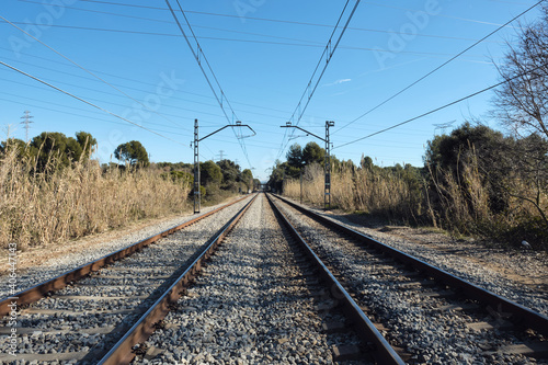 empty railway with electric cables above