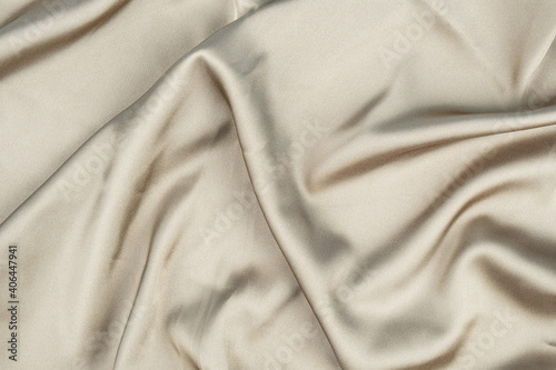 wavy rippled beige silk satin fabric background