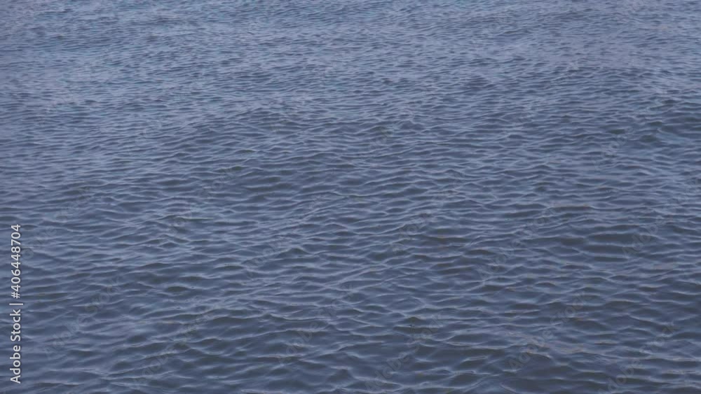 Peaceful, calm ripples of water push toward the coast. Peaceful, calm ripples of water push toward the coast.