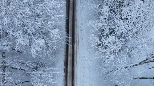 Empty Asphalt Road At Remote Snowscape Forest In The County Of Deby, Poland. - Aerial Drone Shot photo