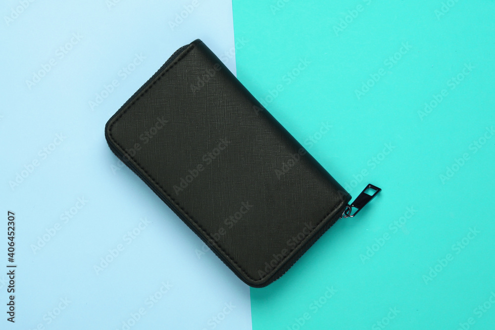 Black stylish wallet on blue pastel background. Top view Black stylish wallet on blue pastel background. Top view