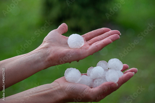 Large hailstones on women's palms in spring