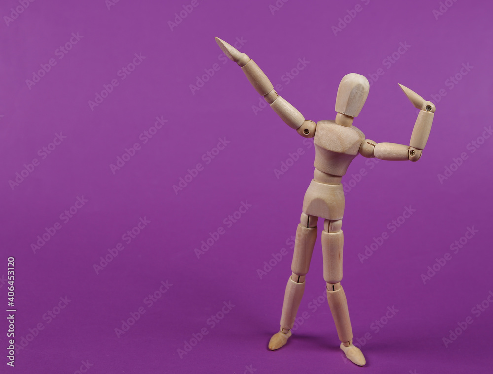 Wooden puppet mannequin posing on a purple background. Wooden puppet mannequin posing on a purple background.