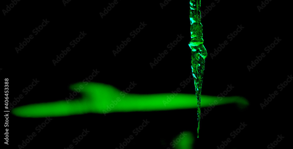 dynamic image showing an icicle with a green glow - obrazy, fototapety, plakaty 