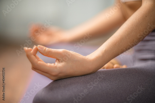 Young woman meditating in the lotus pose at home. Practicing yoga indoors. Harmony  yoga practice  balance  meditation  relaxation at home  healthy lifestyle concept.