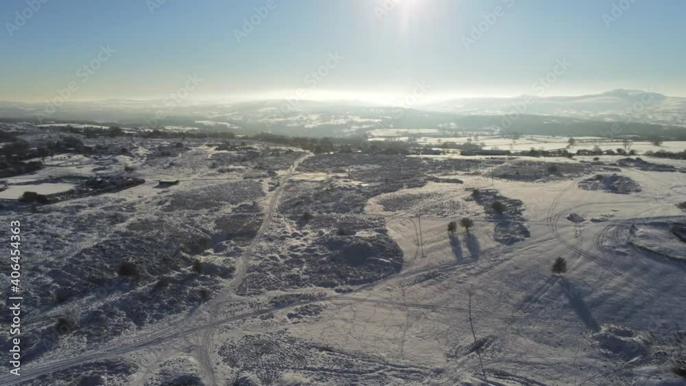 Snow covered rural winter countryside track footprint shadows terrain aerial view tilt down Snow covered rural winter countryside track footprint shadows terrain aerial view tilt down