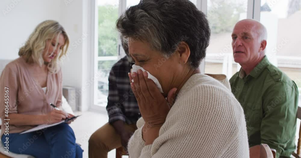 Two diverse senior couples sitting in circle having a therapy conversation at home Two diverse senior couples sitting in circle having a therapy conversation at home