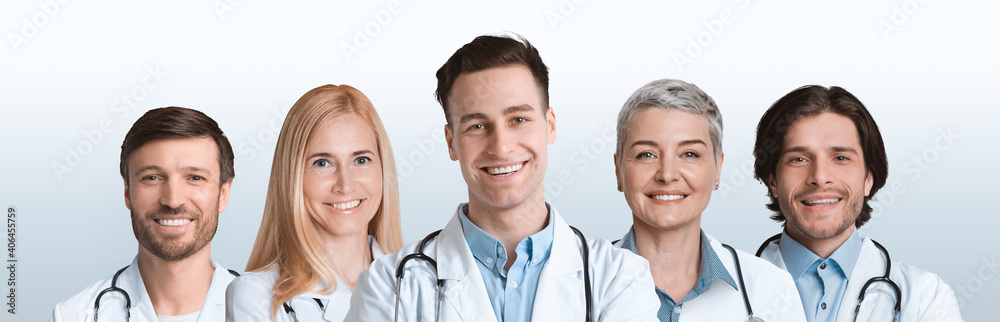 Group Of Five Professional Doctors Posing Over White Studio Background Group Of Five Professional Doctors Posing Over White Studio Background