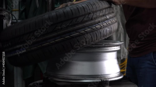 mechanic changing new car tire by tire removal machinery equipment repairing . engineer repair rubber from wheel disc in workshop at car  service garage