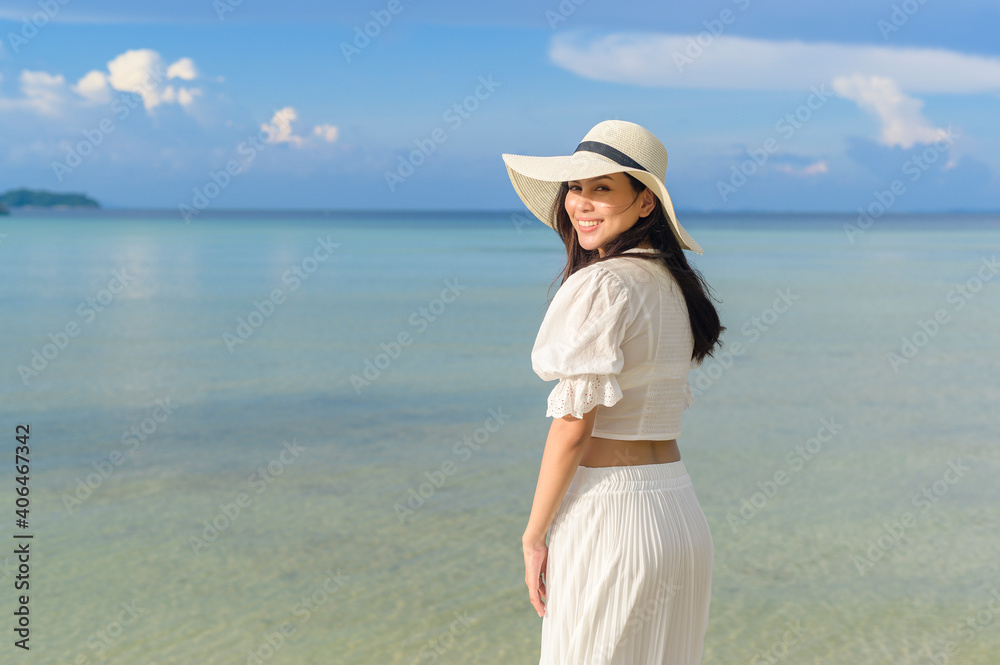 A happy beautiful woman in white dress enjoying and relaxing on the beach, Summer and holidays concept A happy beautiful woman in white dress enjoying and relaxing on the beach, Summer and holidays concept