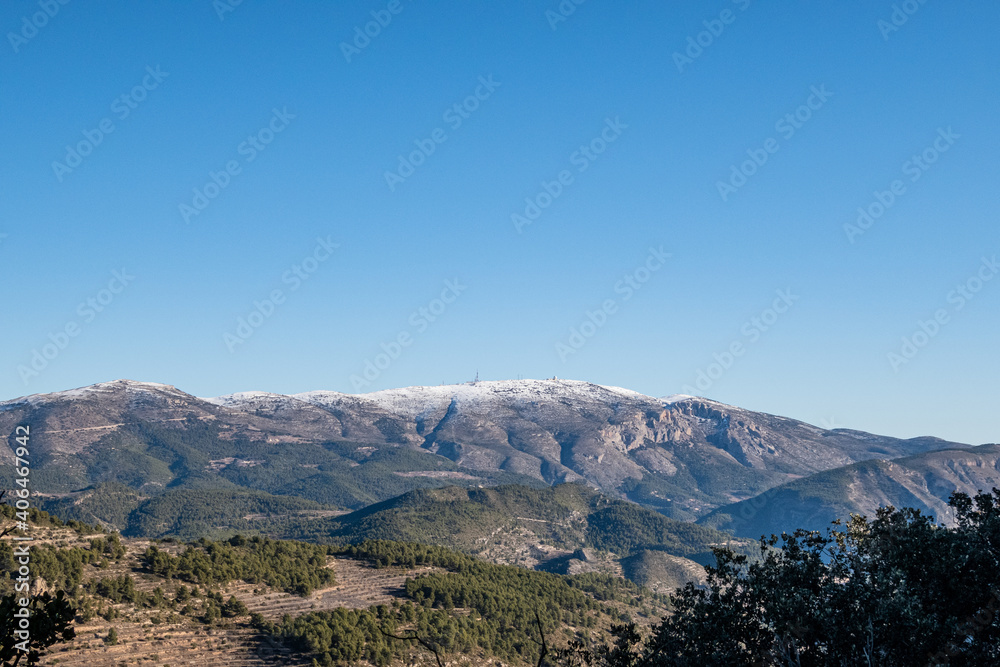 Mount Aitana with snow, on a sunny winter day.