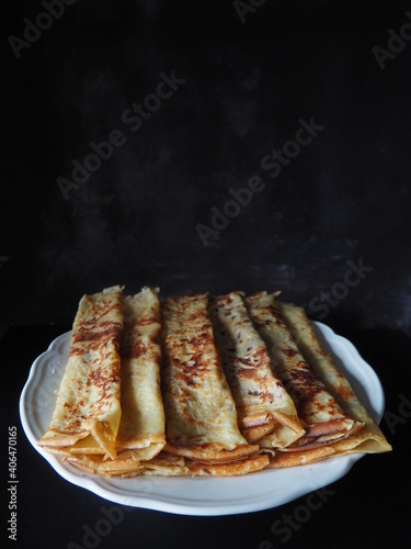 Принти на полотні Homemade crepes, french crêpes, traditionally made for Candlemas, on black backg