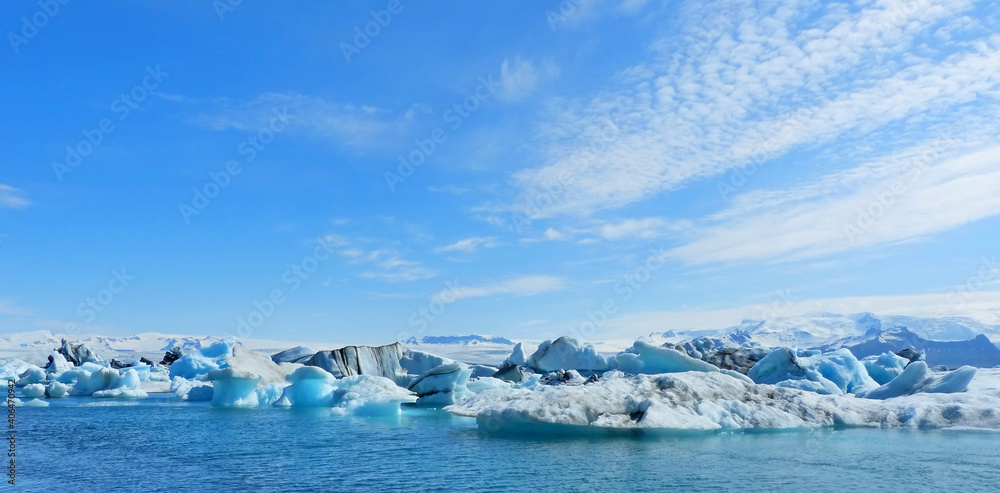 Ice winter panoramic view on glacial lake Jokulsarlon lagoon Iceland, amazing ice floes surreal iceberg snow cupped mountain blue sparkling ice, awesome Icelandic nature, white polar arctic landscape.
