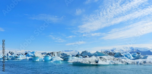 Ice winter panoramic view on glacial lake Jokulsarlon lagoon Iceland, amazing ice floes surreal iceberg snow cupped mountain blue sparkling ice, awesome Icelandic nature, white polar arctic landscape.