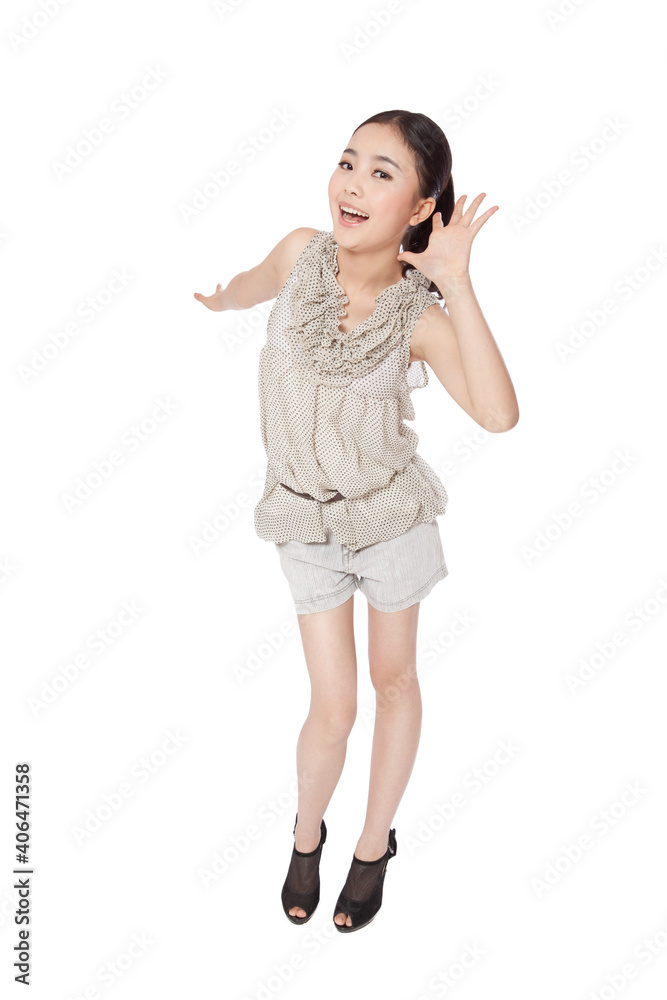 a Young woman cupping hand to ear a Young woman cupping hand to ear