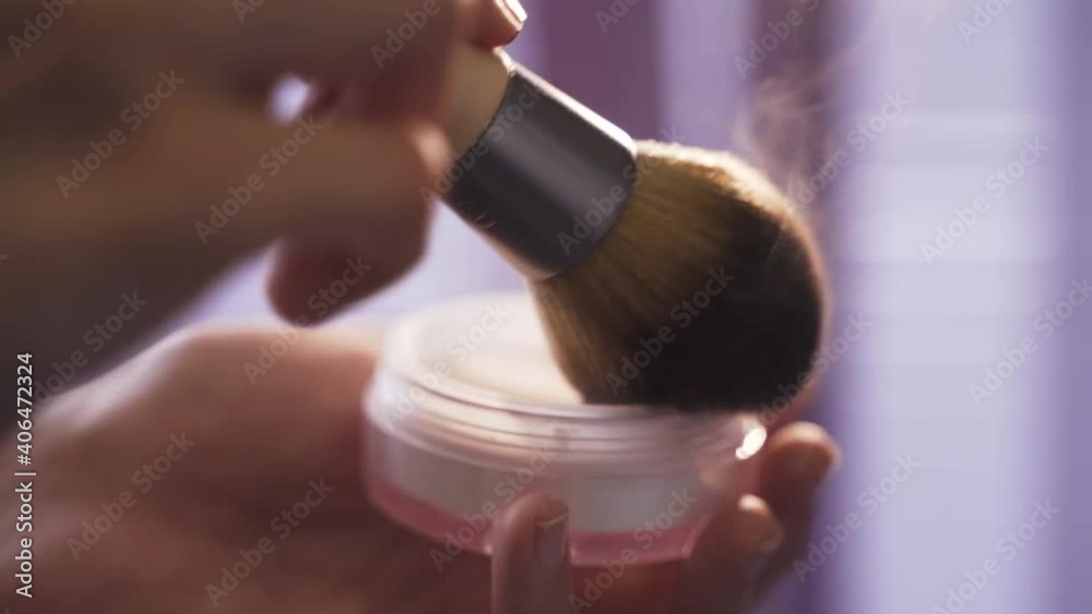 Makeup artist mixes powder with brush. Glitter makeup close-up