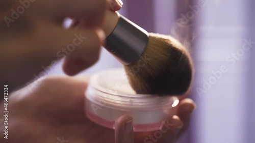 Makeup artist mixes powder with brush. Glitter makeup close-up