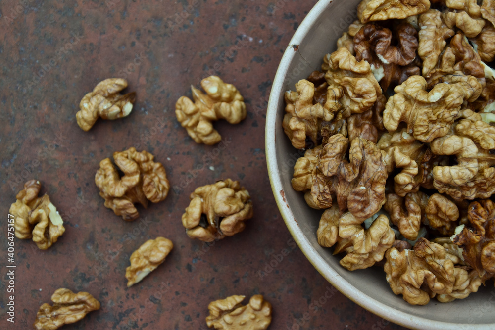 Fototapeta premium Walnuts harvest on vintage metal background. Walnut kernels. Countryside agriculture. Organic autumn nuts harvest.