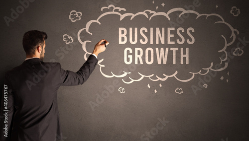 businessman drawing a cloud with BUSINESS GROWTH inscription inside, modern business concept