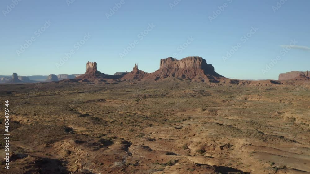 A rising drone aerial shot of monument valley in the distance, Utah, Arizonia A rising drone aerial shot of monument valley in the distance, Utah, Arizonia