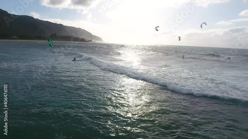Kite surfers ride along way during sunset in Hawaii, Aerial Drone
