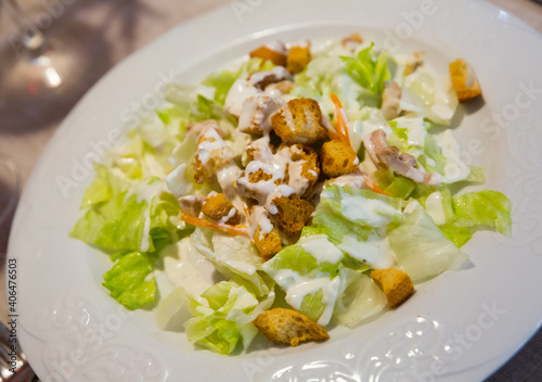 Appetizing Caesar salad with chicken breast, lettuce and toast